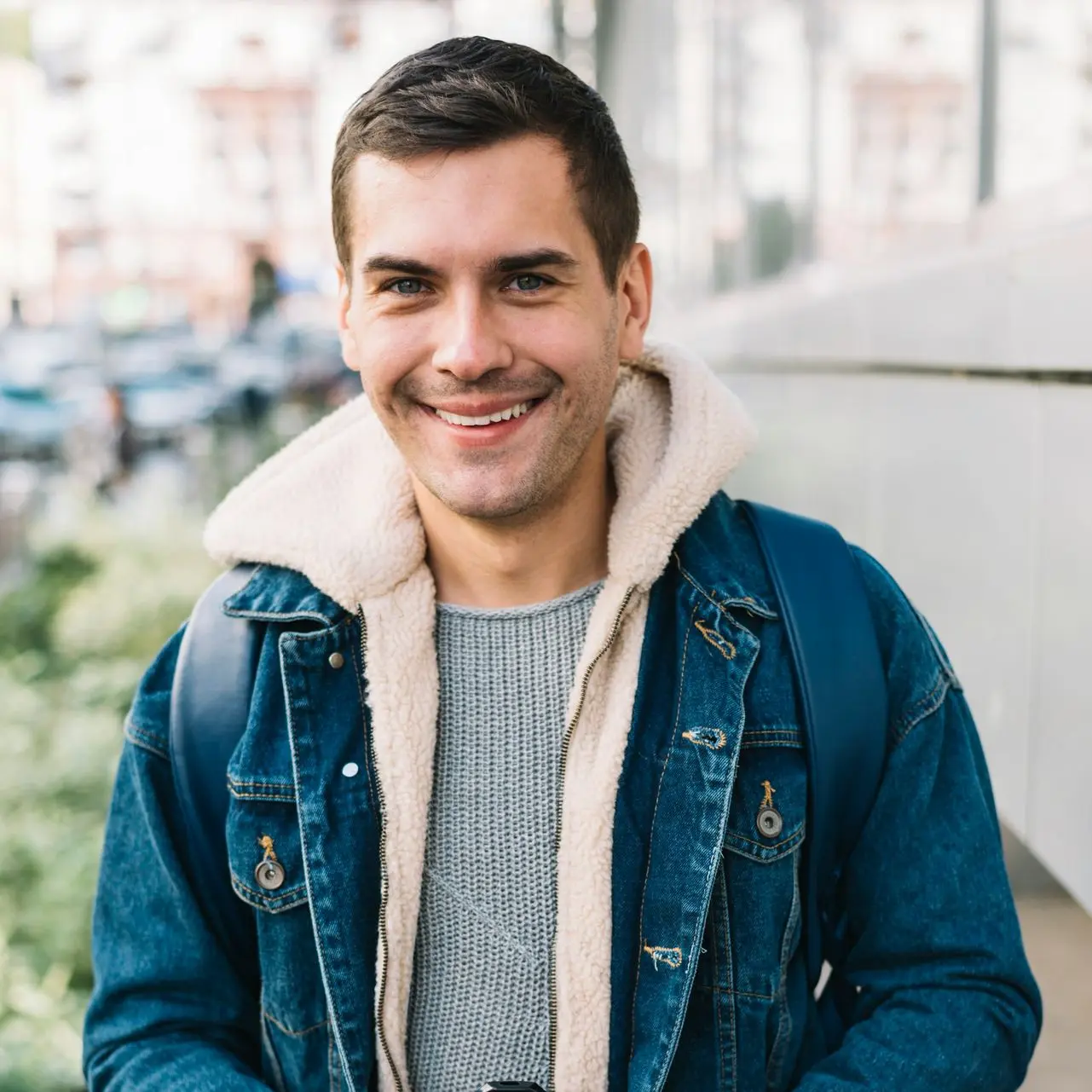 a man holding a cup of coffee and smiling